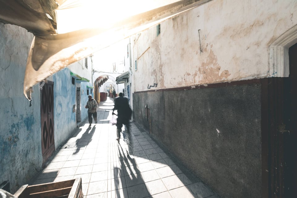 A Narrow Street Which Is Located In Rabat